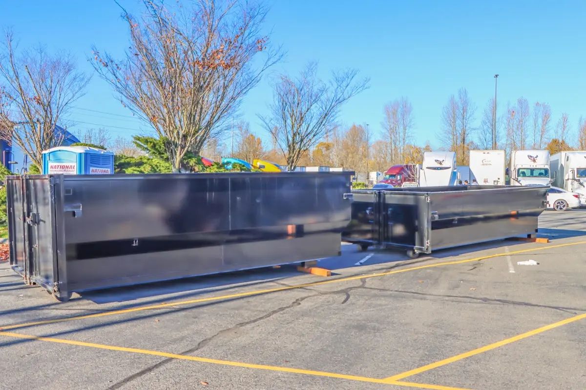 Professional dumpster rental service with roll-off container on residential driveway in Center Line